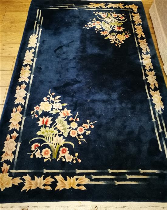 A Chinese midnight blue ground floral embossed rug 240 x 150cm